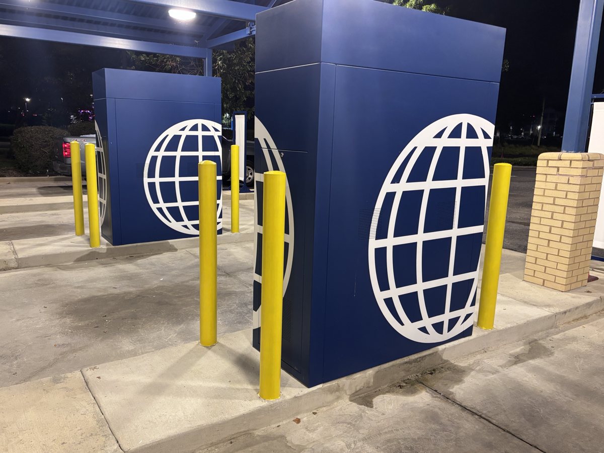 Yellow steel bollards protecting ATM kiosks at a bank drive-thru