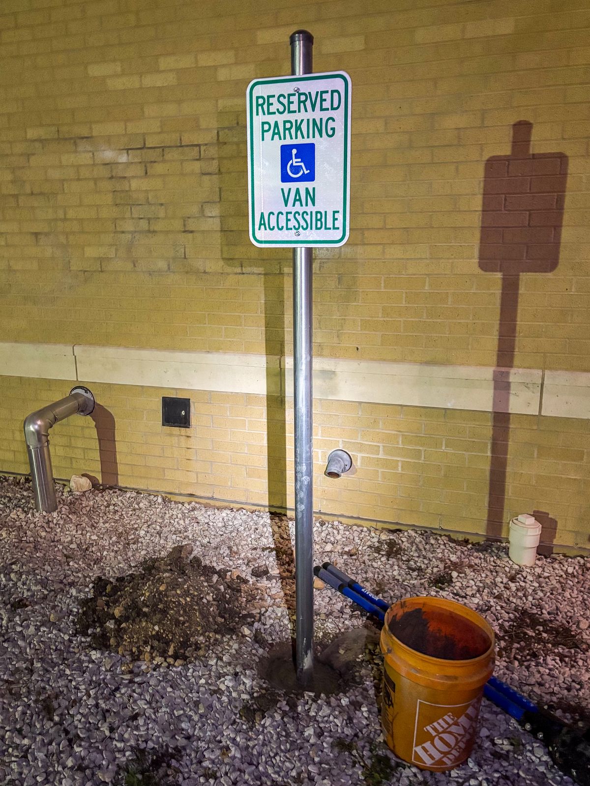 Reserved parking van accessible sign installed on a metal post