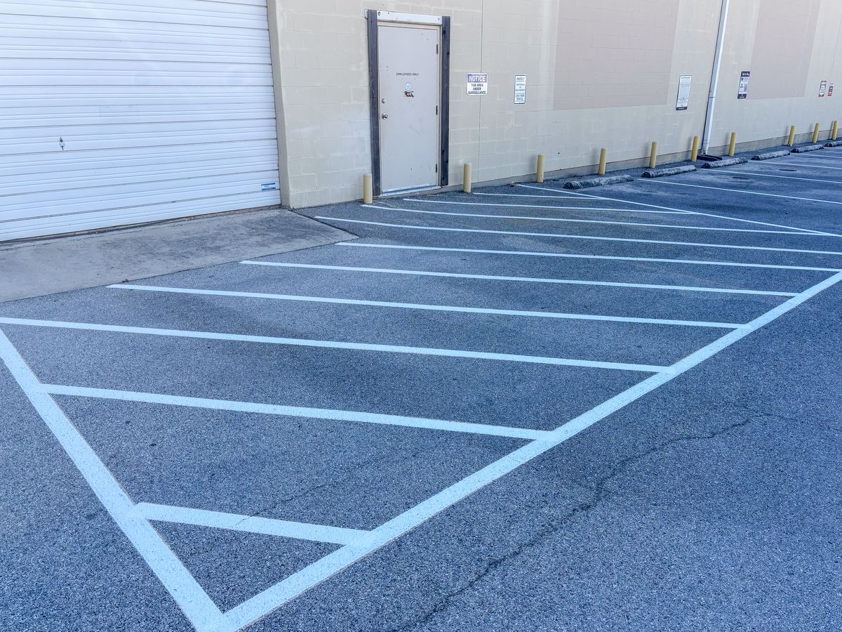 Loading zone with yellow safety bollards protecting a warehouse entrance