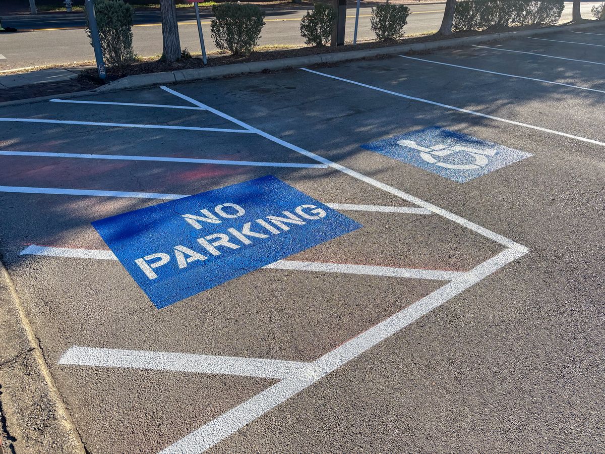 Blue no parking zone marking with handicap symbols