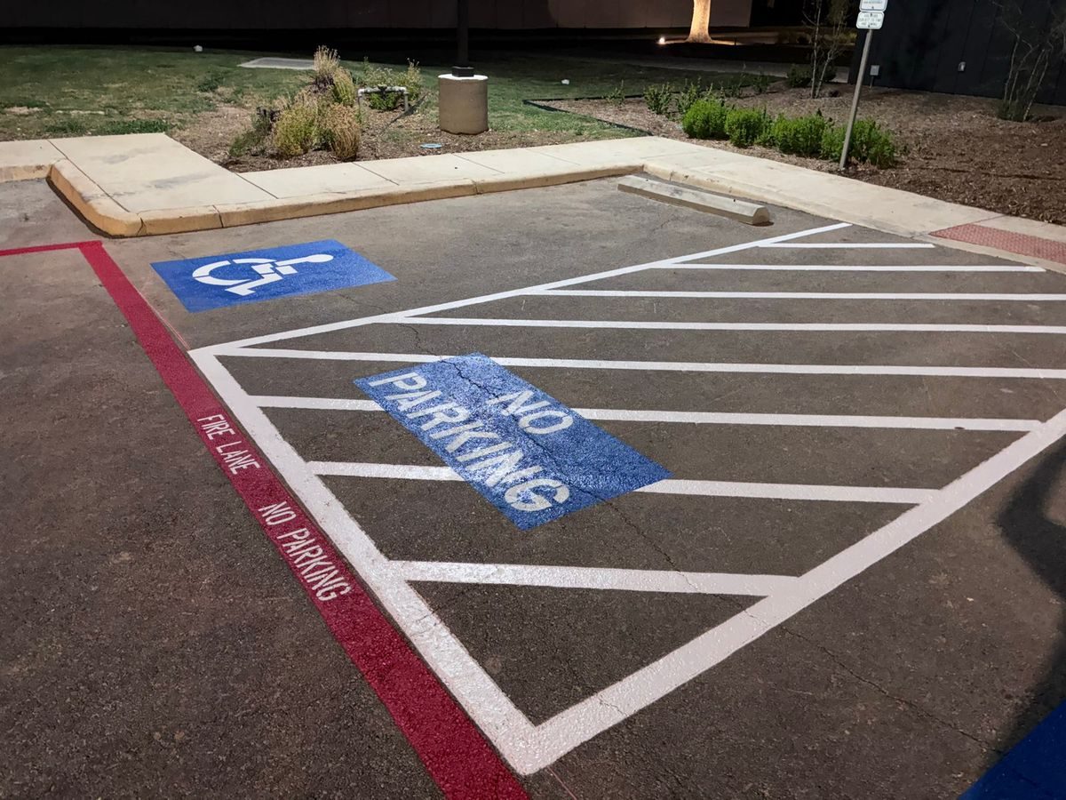 NO PARKING marking inside a crosshatched access aisle