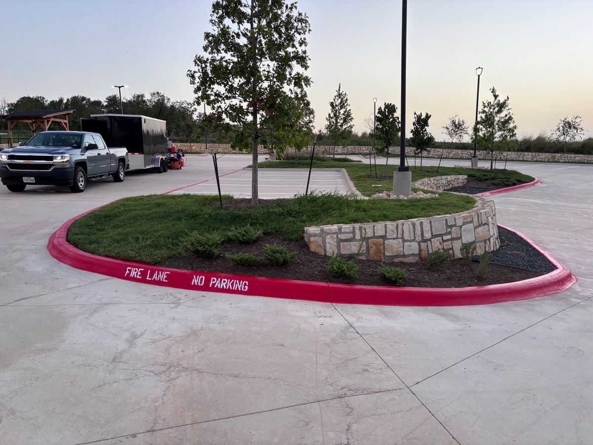Red fire lane curb with stencil around a landscaped island