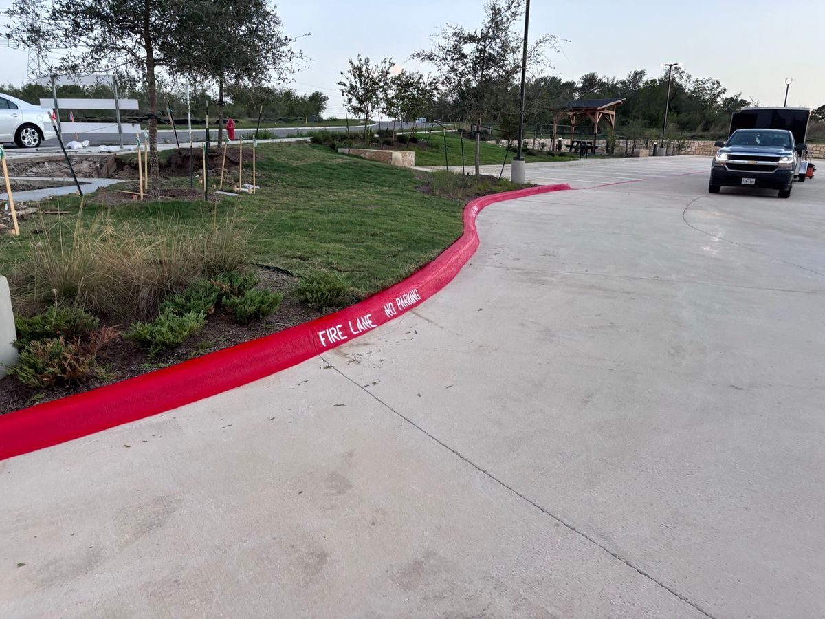 Red fire lane curb following a curved landscaped bed