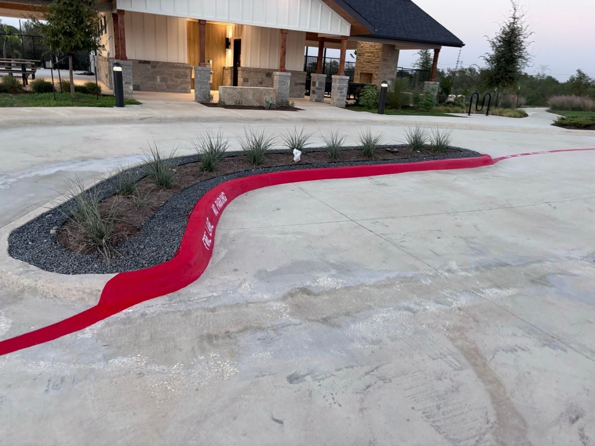 Red fire lane curb along a curving drive